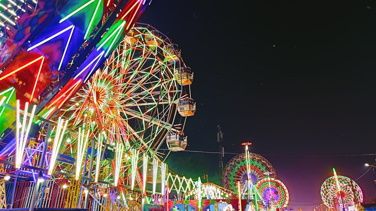 Colorful amusement rides lit at night